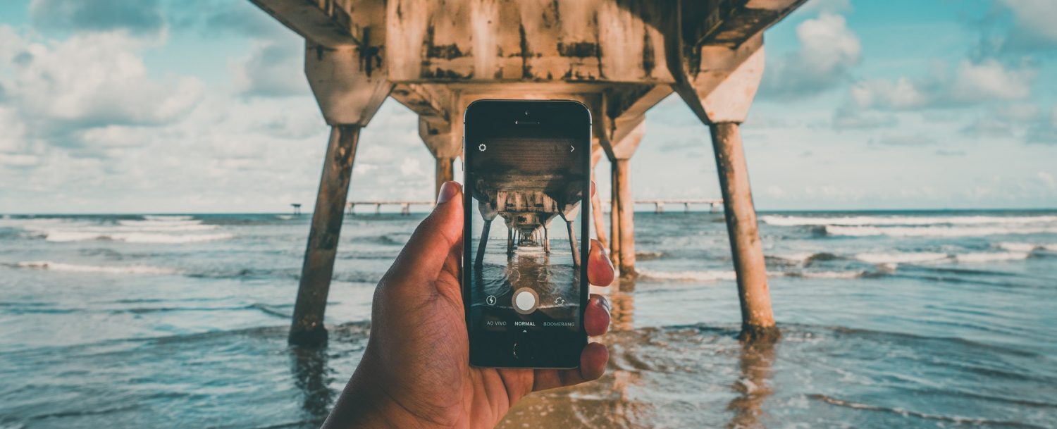 Person taking photo at the beach, one of the most Instagrammable places in Fort Lauderdale