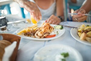 Woman squeezing lemon on seafood at a restaurant in Fort Lauderdale