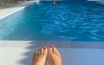 feet photo overlooking a pool with two children playing in it